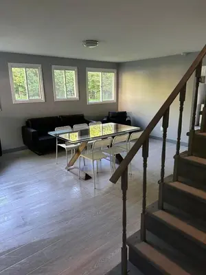 a living room with a glass table and a couch at 5-bedroom Villa in East Gwillimbury in East Gwillimbury
