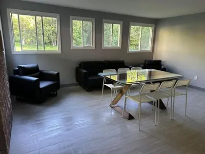 a living room with a table and a couch at 5-bedroom Villa in East Gwillimbury in East Gwillimbury
