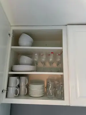 a cabinet filled with plates and glasses and dishes at 5-bedroom Villa in East Gwillimbury in East Gwillimbury