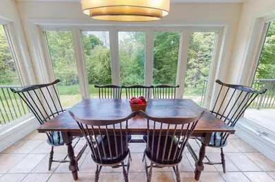 a dining room with a wooden table and chairs at Monterra in Collingwood