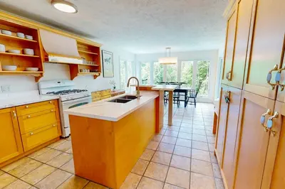 a kitchen with a sink and a table in it at Monterra in Collingwood