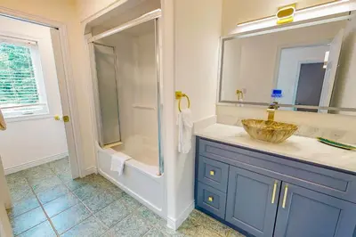 a bathroom with a sink and a glass shower at Monterra in Collingwood