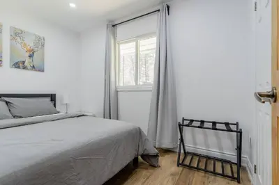a bedroom with a bed and a window at Private cottage with 26 acre & outdoor games in Bracebridge