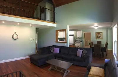 a living room with a couch and a table at Wares Muskoka Lakes Estate in Gravenhurst