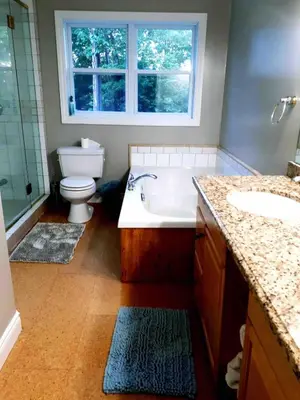 a bathroom with a tub and a toilet and a sink at Wares Muskoka Lakes Estate in Gravenhurst