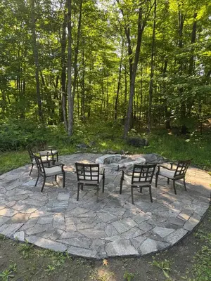 a group of benches sitting around a fire pit at Wares Muskoka Lakes Estate in Gravenhurst