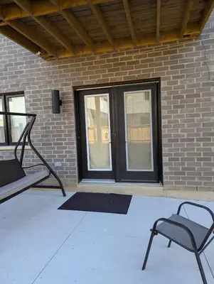 a chair sitting in front of a brick building at Spacious Luxury walk out Basement in Kitchener