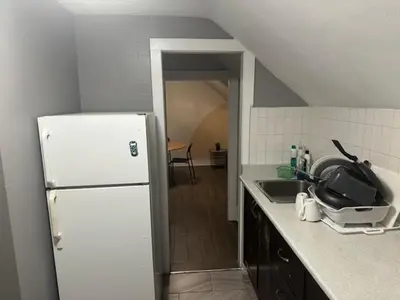 a kitchen with a white refrigerator and a sink at Maple Falls Oasis By Tig Management in Niagara Falls