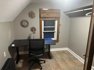 a desk with a chair and a window in a room at Maple Falls Oasis By Tig Management in Niagara Falls