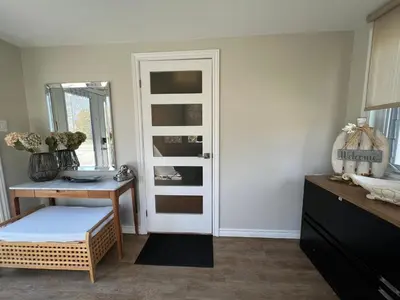 a room with a door and a table and a mirror at The Beach House - Steps to Beach Area 3 4BR in Wasaga Beach