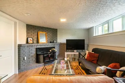 a living room with a couch and a fireplace at The Beach House - Steps to Beach Area 3 4BR in Wasaga Beach