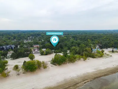 an overhead view of a beach with a blue sign at The Beach House - Steps to Beach Area 3 4BR in Wasaga Beach