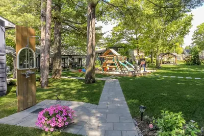 a backyard with a park with a playground at The Beach House - Steps to Beach Area 3 4BR in Wasaga Beach