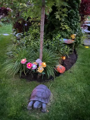 a statue of a turtle in a garden at Spacious Ground Floor Garden View Apartment in Wasaga Beach