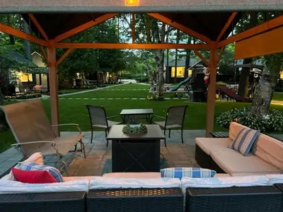 a patio with couches and a table and a gazebo at The Cozy Shore Cottage - Standard Attached in Wasaga Beach
