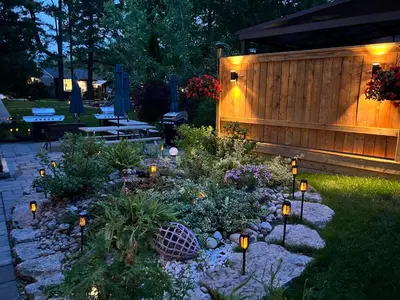 a garden with lights in the yard at night at The Cozy Shore Cottage - Standard Single in Wasaga Beach