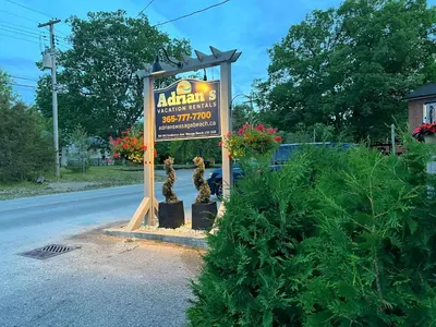 a sign for a restaurant on the side of the road at The Cozy Shore Cottage - Standard Single in Wasaga Beach