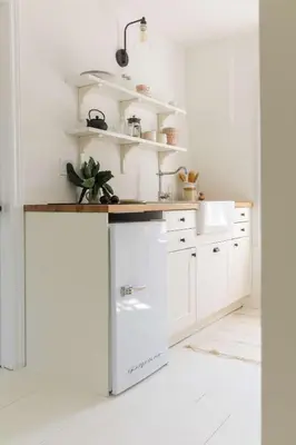 a kitchen with white cabinets and a counter at The Wild Rose - Cozy PEC Rental in Picton in Picton