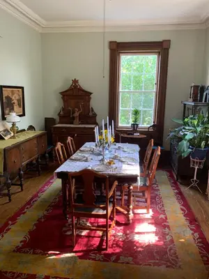 a dining room with a table with candles on it at The House of Elsie Bed and Breakfast in Niagara on the Lake