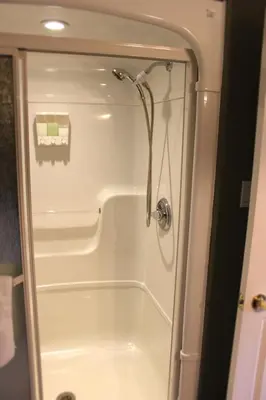 a shower in a bathroom with a glass door at Forest Hill Bed and Breakfast in Kitchener