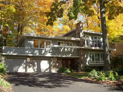 a large house with a balcony on top of it at Forest Hill Bed and Breakfast in Kitchener