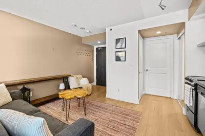 a living room with a couch and a table at RivetStays - The Pantages Suite in Toronto