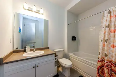 a bathroom with a sink and a toilet and a tub at Brand New 7beds-kingbedsfamilysleep15playtable in Milton