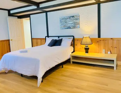 a bedroom with a bed and a table with a lamp at Amazing Unique House in Richmond Hill in Richmond Hill