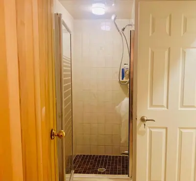 a bathroom with a shower with a glass door at Amazing Unique House in Richmond Hill in Richmond Hill