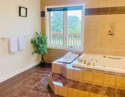 a large bathroom with a tub and a window at Amazing Unique House in Richmond Hill in Richmond Hill