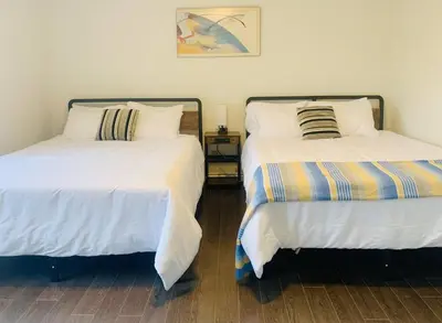 two beds sitting next to each other in a room at Amazing Unique House in Richmond Hill in Richmond Hill