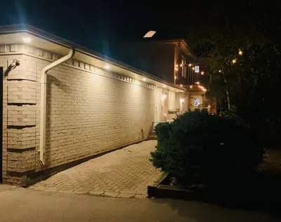 a brick wall with lights on the side of a house at Amazing Unique House in Richmond Hill in Richmond Hill