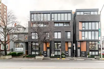 a large brick building on a city street at Westend Suites - Beautifully Furnished 3BR Apartment Close to High Park in Toronto