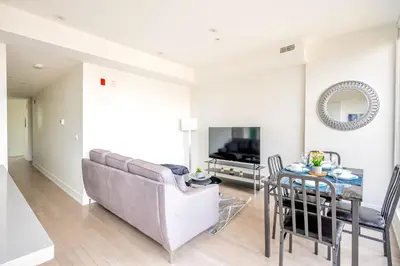 a living room with a couch and a table at Westend Suites - Contemporary 3BR with Natural Light High Park North in Toronto