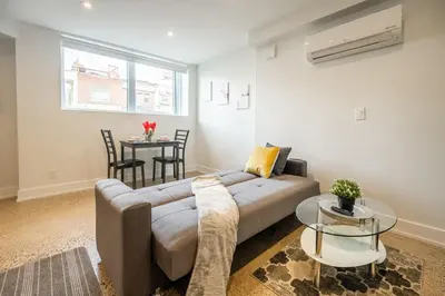 a living room with a couch and a table at Westend Suites - Modern 1BR Apartment - 8min walk to High Park in Toronto