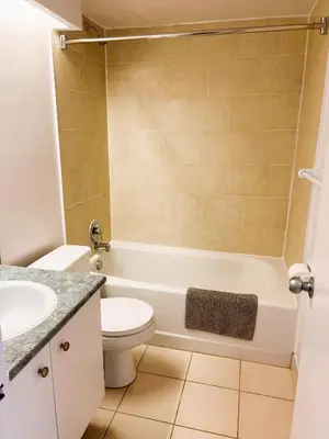 a bathroom with a toilet and a sink at The Charming Downtown Stop in Toronto