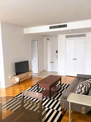a living room with a couch and a tv at The Charming Downtown Stop in Toronto