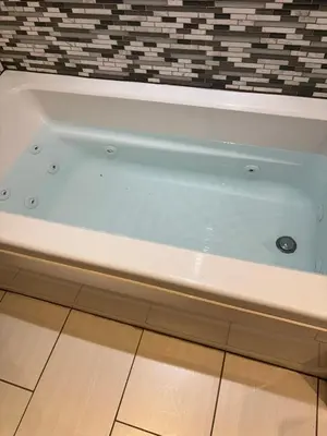 a white bath tub sitting on top of a floor at Chapman H in Toronto