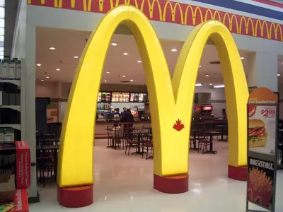 a mcdonalds restaurant with a large yellow mcdonalds sign in a mall at Chapman H in Toronto