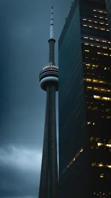 a tall tower with lights on it next to a building at Chapman H in Toronto