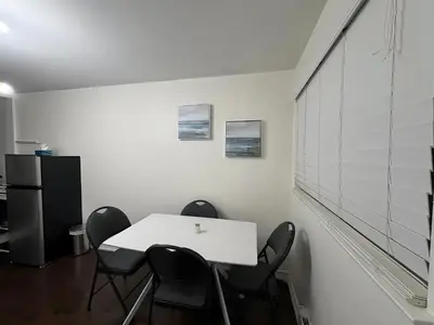 an office with a white table and black chairs at Chapman H in Toronto