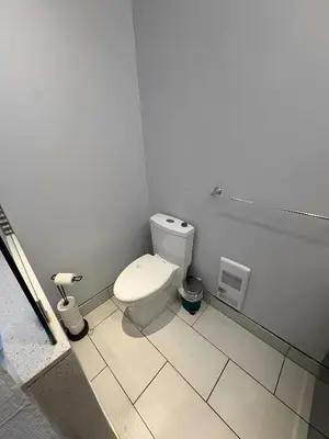 a bathroom with a white toilet in a room at Chapman H in Toronto