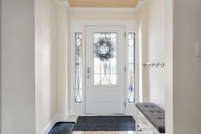 a hallway with a white door and a rug at Family 4BDR 2BA with Basement in Mississauga in Mississauga