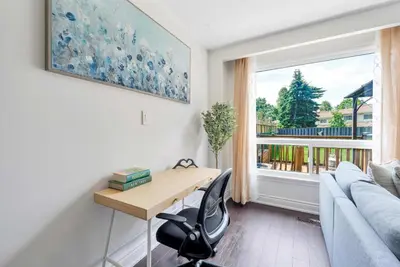 a living room with a desk and a couch and a window at Family 4BDR 2BA with Basement in Mississauga in Mississauga