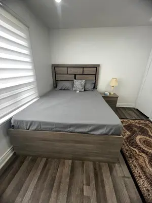 a bedroom with a large bed in a room at Three Bedroom Spacious Bangalow with Free Parking, closer to commercial area and highways in Mississauga