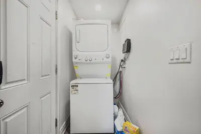 a small room with a water heater and a machine at Chic 2 BR Urban Retreat Near Beach Free Parking in Oshawa