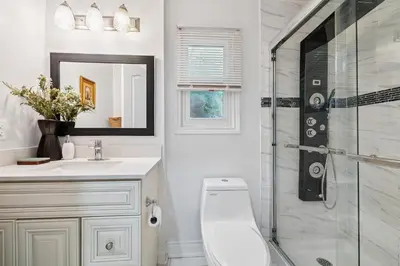 a bathroom with a toilet and a glass shower at Ora's Place BNB in Niagara Falls