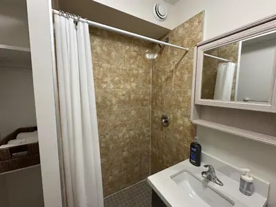 a bathroom with a sink and a shower at Furnished Simcoe Lofts in Oshawa