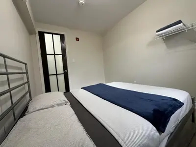 a bedroom with two beds and a window at Furnished Simcoe Lofts in Oshawa