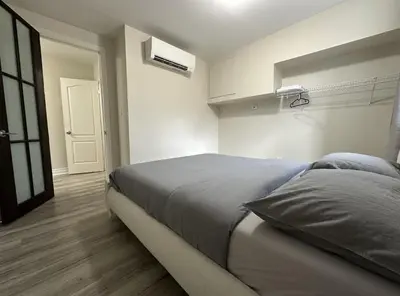 a bedroom with a large bed in a room at Furnished Simcoe Lofts in Oshawa